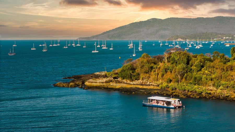 Airlie Beach: 2-Hour Sunset Cruise with Sparkling Wine - Cruising Pioneer Bay as Airlie lights up