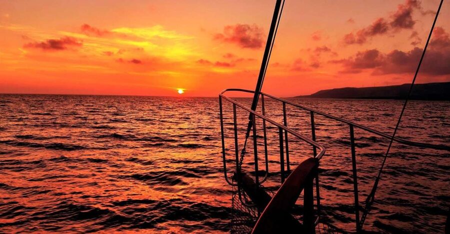Argostoli: Sunset Cruise with Swim Stops, Dinner, and Wine - Sunset over Kefalonia, then a darker ride home