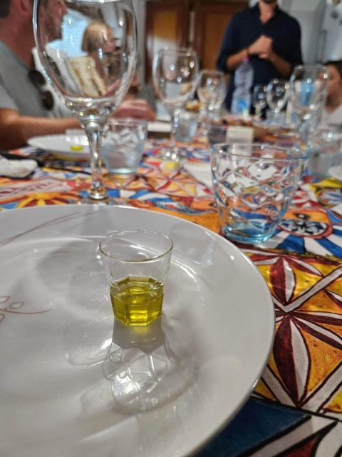 Balestrate: Olive Grove Tour with Wines & Olive Oil Tasting - The tasting table: oil, wine, vinegar, and limoncello