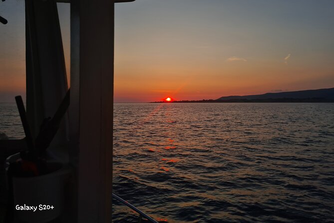 Dreamy Cruise sunset tour with dinner and unlimited wine! - Xi Beach after dark