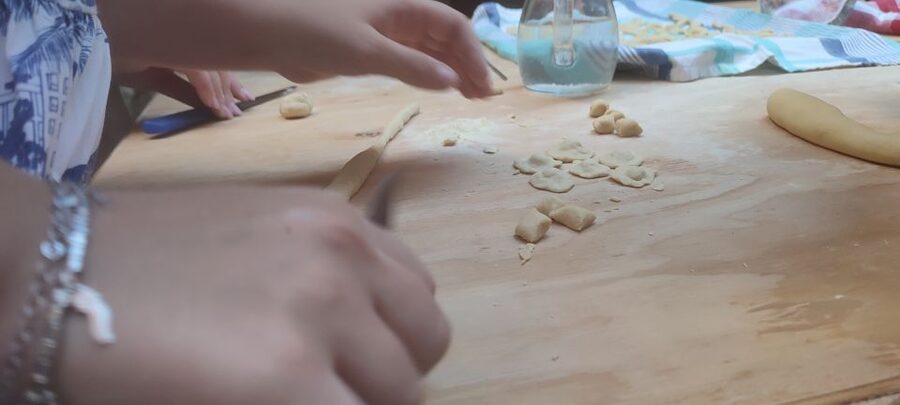 Lecce: Pasta Making Class in 1400s-Era Courtyard with Wine - Mixing flour and water with a local cook