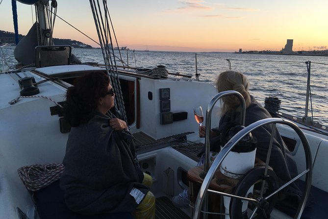 Lisbon Sunset Sailing Tour with White or Rosé Wine and Snacks - What the boat feels like after sunset