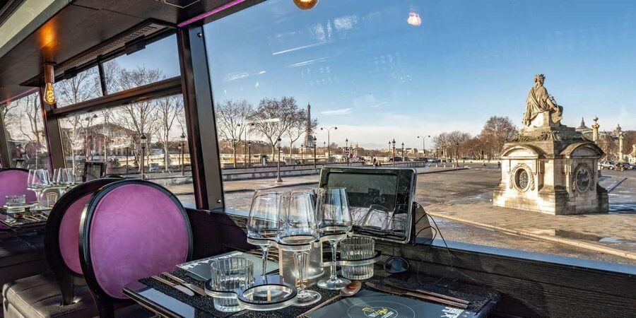 Paris: Champs Elysées Bus Toqué w/Lunch & Glass of Champagne - Paris sightseeing with a table by the window
