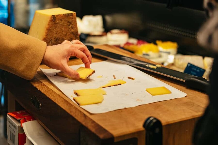 Paris: Gourmet Food Tour with Over 10 Tastings and Wine - The Louvre-area cheese shop