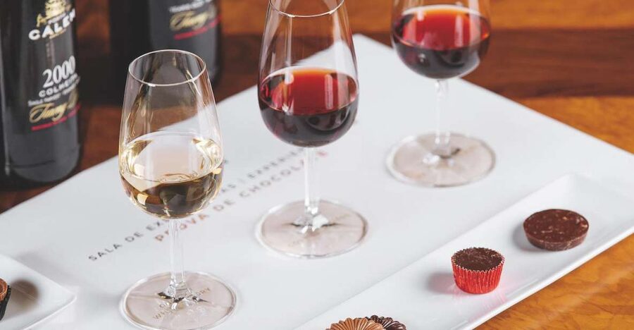 Porto: Cálem Cellar with Chocolate, Cheese, and Wine Tasting - Walking beside barrels in an active cellar