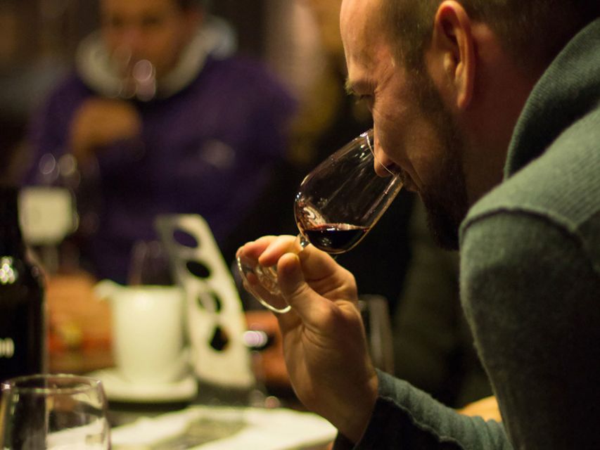 Porto: Self-Guided Bike and Boat Tour with Port Wine Tasting - A rabelo boat beneath Porto’s historic bridges