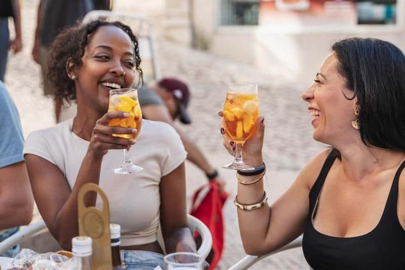 Private Lisbon Food Tour in Baixa with Wine & Local Delights - Meeting the guide beneath the Portuguese flag