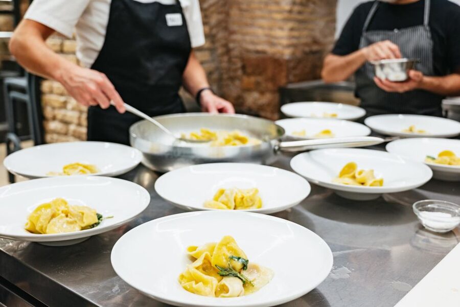 Rome: Hands-On Pasta & Tiramisu Class with Unlimited Wine - Sitting down to eat with wine