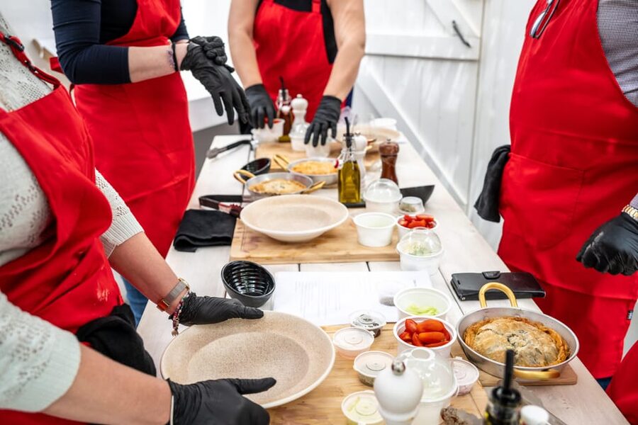 Santorini: Cooking Class with Lunch and Wine Tasting - Cooking Greek food beside Kamari’s black sand