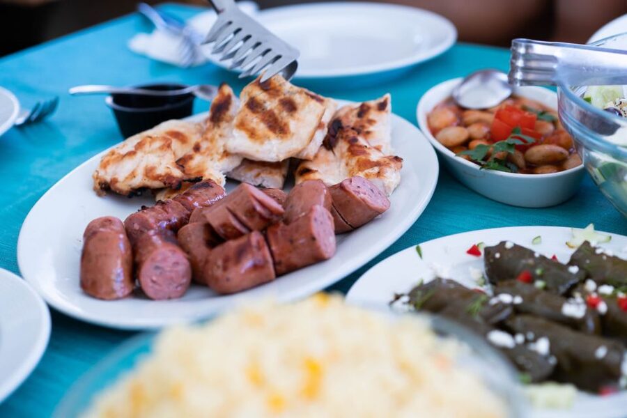 Santorini: Traditional Wooden Boat Tour with Meal and Wine - Swimming at Black Mountain