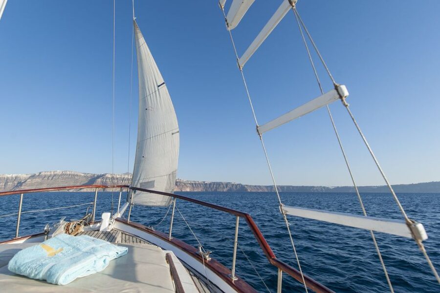 Santorini: Traditional Wooden Boat Tour with Meal and Wine - The Akrotiri Lighthouse and the caldera cliffs