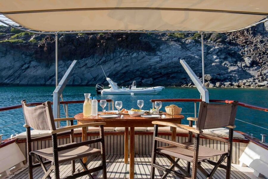 Santorini: Traditional Wooden Boat Tour with Meal and Wine - Choosing the daytime or sunset departure