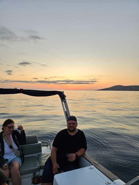 Sarandë: Sunset boat tour with local wine - Secret Beach and the longer swimming stop