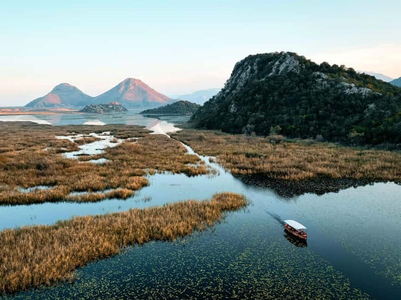 Skadar Lake: Guided Sunset Boat Tour with Wooden Boat & Wine - Three islands and the lotus channels