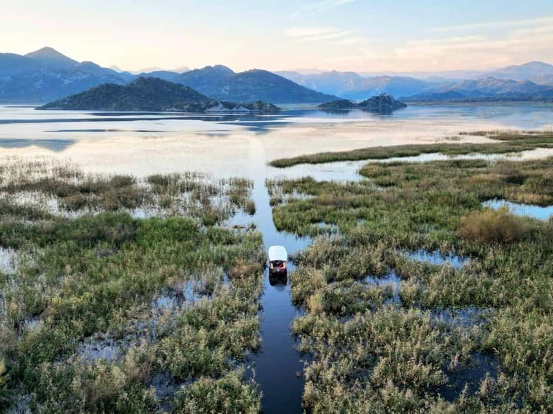 Skadar Lake: Guided Sunset Boat Tour with Wooden Boat & Wine - Through Lake Skadar National Park