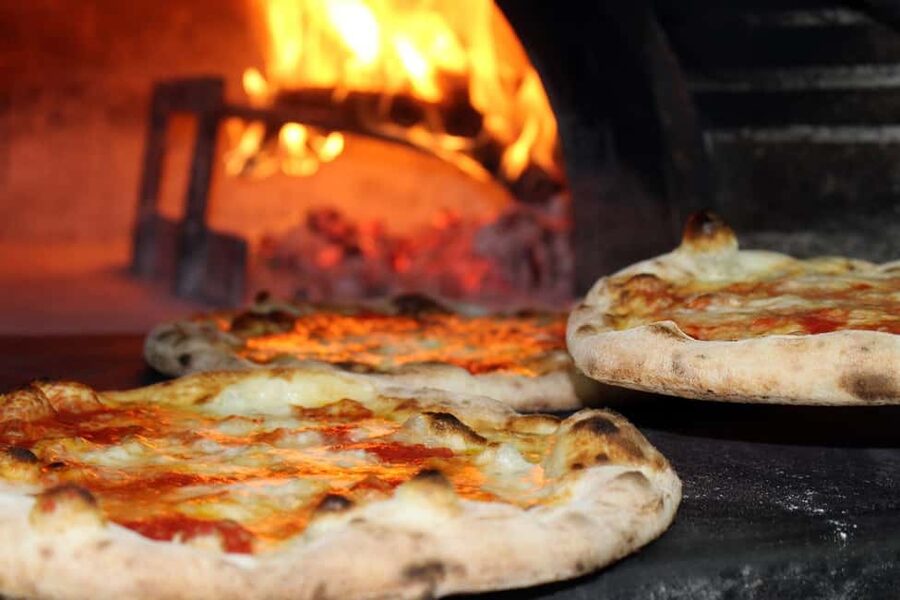 Taormina: Pizza Making Class with Lunch and Wine Tasting - A full table of pizza, pasta, cheese, and wine